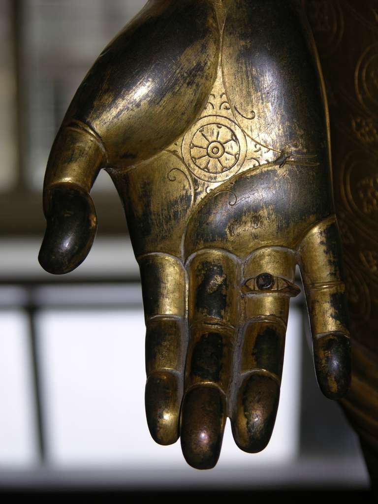 British Museum Top 20 Buddhism 09-3 Standing Avalokiteshvara Hand Close Up Standing Avalokiteshvara � Nepal, 16C AD, 138cm high. Here is a close up of the palm of Avalokiteshvara�s right hand, held in the giving (charity) mudra and showing the lotus and chakra (wheel).